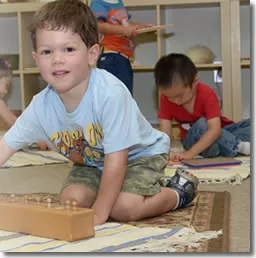 Montessori Pic 3 Kid playing on floor
